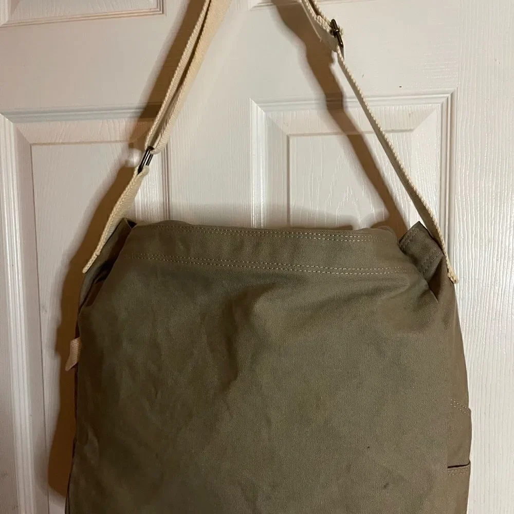 Lucky Brand large canvas olive green messenger bag with adjustable beige strap.